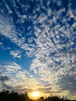 Beautiful fluffy white beautiful cloud formations in a deep blue summer sky