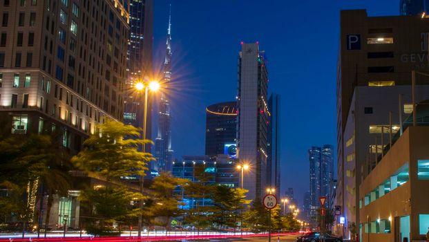 Light trails on Dubai Financial Center road. Address Sky view and Ritz Carlton hotel can be seen in the picture. Outdoors