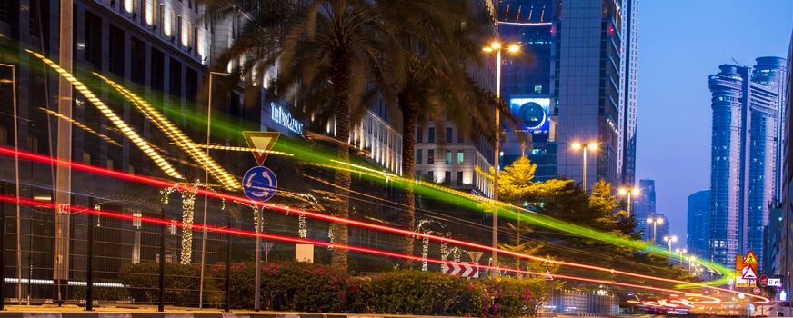 Light trails on Dubai Financial Center road. Address Sky view and Ritz Carlton hotel can be seen in the picture. Outdoors