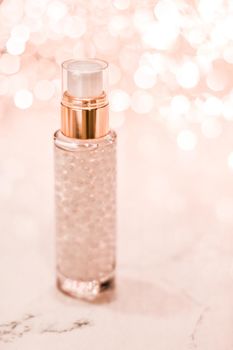 Cosmetic branding, blank label and glamour present concept - Holiday make-up base gel, serum emulsion, lotion bottle and rose gold glitter, luxury skin and body care cosmetics for beauty brand ads