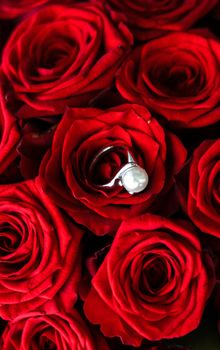 Gemstone jewellery, wedding present and engagement proposal concept - Beautiful white gold pearl ring and bouquet of red roses, luxury jewelry love gift on Valentines Day and romantic holidays