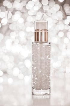 Cosmetic branding, blank label and glamour present concept - Holiday make-up base gel, serum emulsion, lotion bottle and silver glitter, luxury skin and body care cosmetics for beauty brand ads