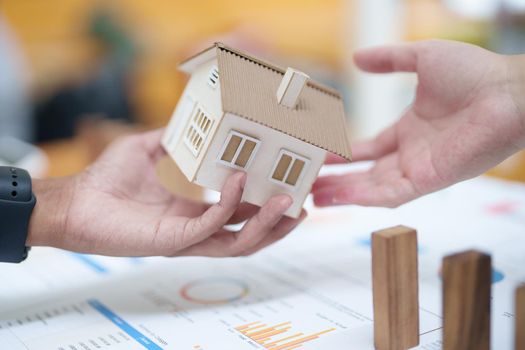 Model house and wooden stick, insurance concept.