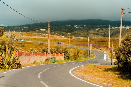 Portugal, Sintra May 2022 Winding country road near Sintra mountain with rainy clouds Hot summer