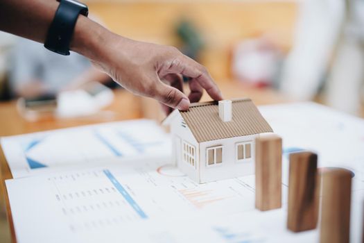 Model house and wooden stick, insurance concept.