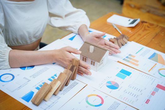 A portrait of a bank employee gesturing to protect a home from insurance to reduce the risk of investing, borrowing or buying a home