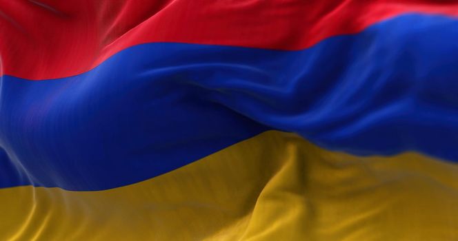 Close-up view of the armenian national flag waving in the wind. Armenia is a landlocked country located in the Armenian Highlands of Western Asia. Fabric textured background. Selective focus