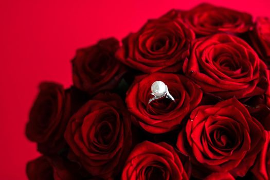 Gemstone jewellery, wedding present and engagement proposal concept - Beautiful white gold pearl ring and bouquet of red roses, luxury jewelry love gift on Valentines Day and romantic holidays