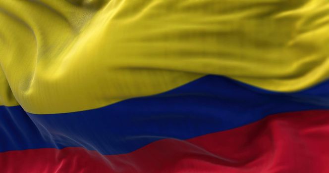 Close-up view of the Colombia national flag waving in the wind. The Republic of Colombia is a country in South America. Fabric textured background. Selective focus