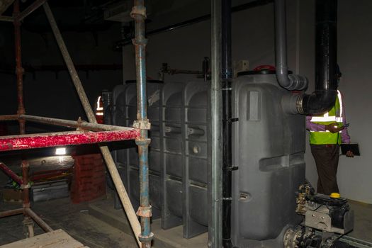 Shot of a grease trap in a basement of a under construction building