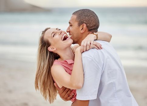 Beach, hug and happy couple celebrate love, dating and marriage at sea, ocean water or luxury vacation travel. Man and woman smile on date in celebration for surprise and joy sunset summer holiday.
