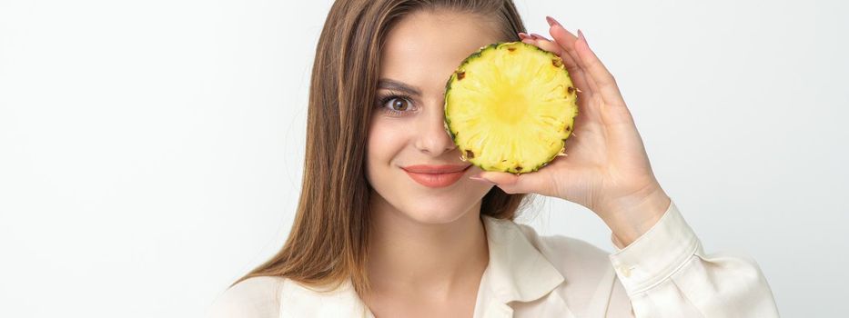 Attractive pretty nice young caucasian woman hold sliced pineapple covering her eye isolated on white color background