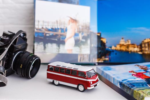The concept of trip for a travel company. toy bus, plane and photo book, photo album.