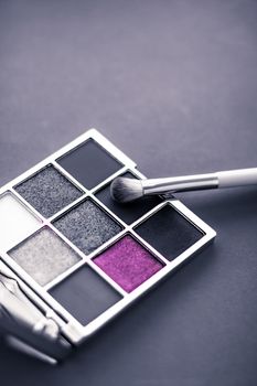 Cosmetic branding, mua and girly concept - Eyeshadow palette and make-up brush on graphite background, eye shadows cosmetics product for luxury beauty brand promotion and holiday fashion blog design