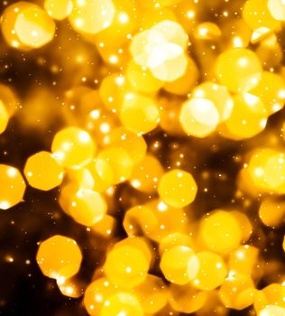 Golden Christmas lights, New Years Eve fireworks and abstract texture concept - Glamorous gold shiny glow and glitter, luxury holiday background