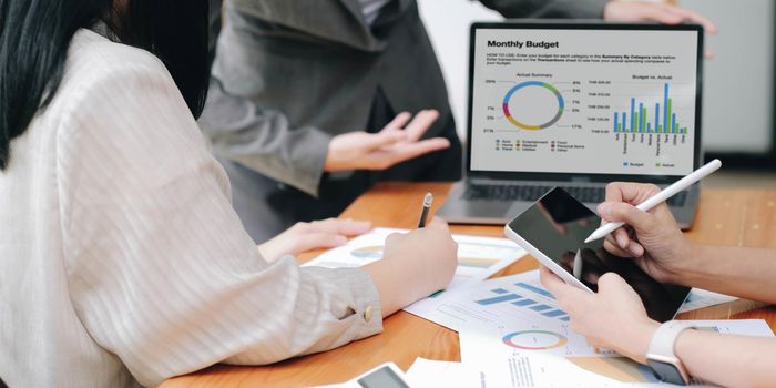 Close up asian business adviser meeting to analyze and discuss the situation on the financial report in the meeting room.Investment Consultant, Financial advisor and accounting concept.