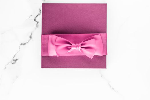 Birthday, wedding and girly branding concept - Pink gift box with silk bow on marble background, girl baby shower present and glamour fashion gift for luxury beauty brand, holiday flatlay art design