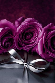 Luxurious design, shop sale promotion and happy surprise concept - Luxury holiday silver gift box and purple roses as Christmas, Valentines Day or birthday present