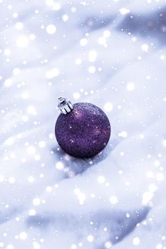 Gift decor, New Years Eve and happy celebration concept - Violet Christmas baubles on fluffy fur with snow glitter, luxury winter holiday design background