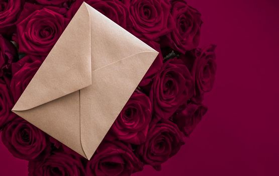 Holidays gift, floral present and happy relationship concept - Love letter and flowers delivery on Valentines Day, luxury bouquet of roses and card on maroon background for romantic holiday design