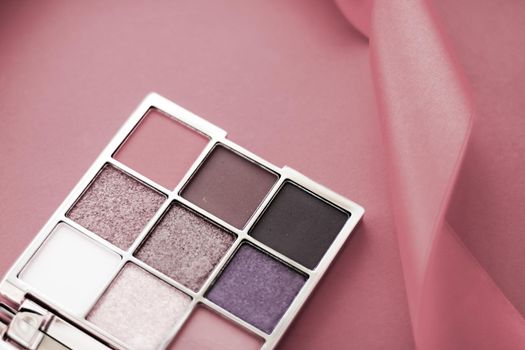 Cosmetic branding, mua and girly concept - Eyeshadow palette and make-up brush on rouge background, eye shadows cosmetics product for luxury beauty brand promotion and holiday fashion blog design