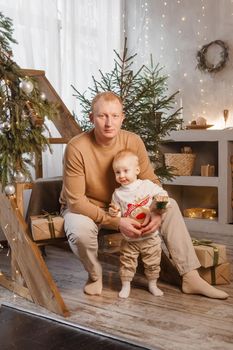 Dad and his little son in a magical Christmas atmosphere. The concept of family relations and New Year celebrations