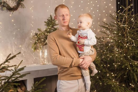 Dad and his little son in a magical Christmas atmosphere. The concept of family relations and New Year celebrations