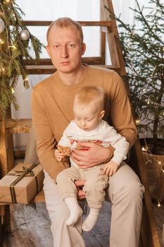 Dad and his little son in a magical Christmas atmosphere. The concept of family relations and New Year celebrations