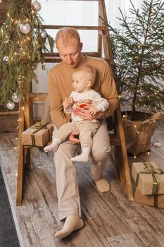 Dad and his little son in a magical Christmas atmosphere. The concept of family relations and New Year celebrations