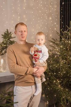 Dad and his little son in a magical Christmas atmosphere. The concept of family relations and New Year celebrations