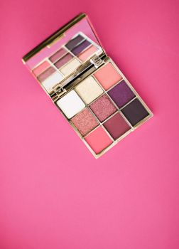 Cosmetic branding, mua and girly concept - Eyeshadow palette and make-up brush on rose background, eye shadows cosmetics product for luxury beauty brand promotion and holiday fashion blog design