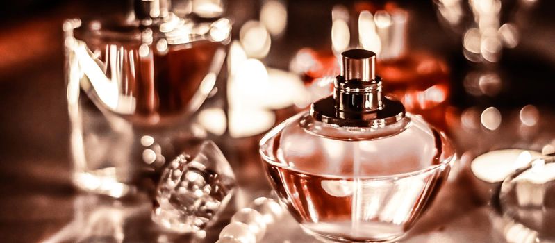 Perfumery, cosmetics branding and luxe concept - Perfume bottle and vintage fragrance on glamour vanity table at night, pearls jewellery and eau de parfum as holiday gift, luxury beauty brand present