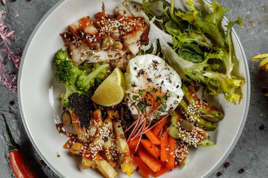Healthy bowl - quinoa salad with tuna, broccoli, avocado on wooden rustic table. top view.