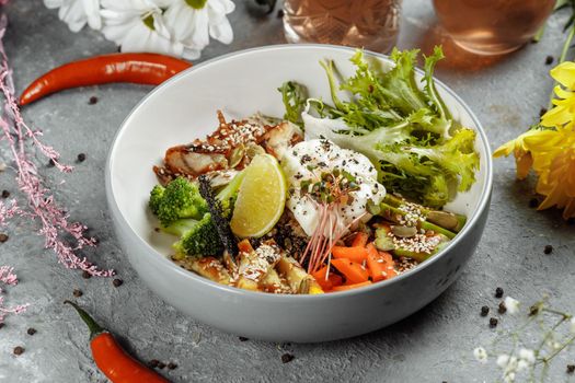 Healthy bowl - quinoa salad with tuna, broccoli, avocado on wooden rustic table. top view.