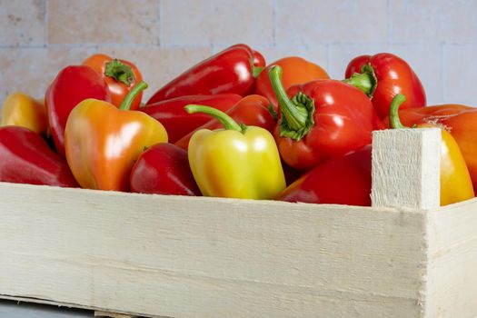 Wooden box with ripe sweet peppers. Harvest. Selective focus.