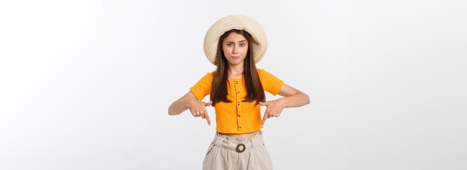 young pretty woman looking unhappy and stressed, suicide gesture making gun sign with hand, pointing to copy space