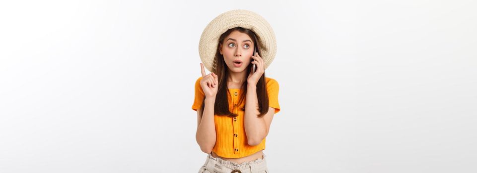 Picture of surprised voyage girl looking shock while holding phone in hands isolated over grey background.