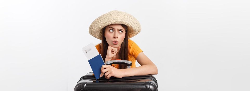 Lifestyle and travel Concept: Young beautiful caucasian woman is sitting on suitecase and waiting for her flight.Isolated over white background.