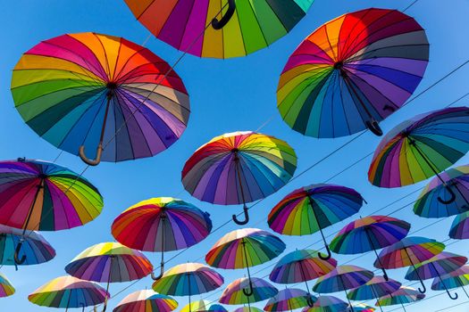 Colorful umbrellas in the sky. Colorful umbrellas background. Street decoration.
