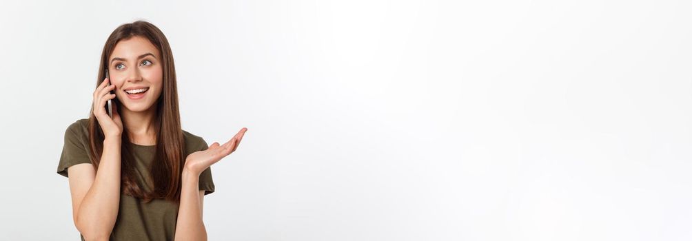 Laughing woman talking and texting on the phone isolated on a white background