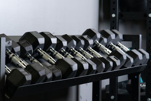 Dumbbell gym blurry wall home set storage rig equipment, concept studio taking in heavy from bodybuilder hand, activity hard. ,