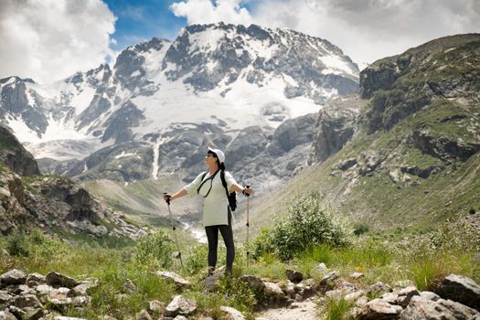A woman with backpack in the mountains Caucasus