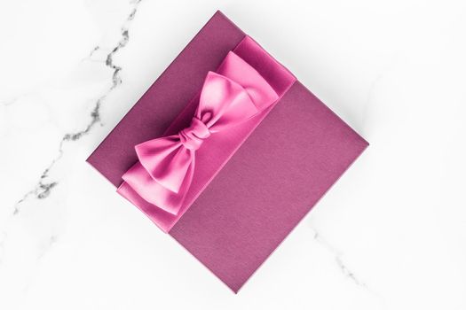 Birthday, wedding and girly branding concept - Pink gift box with silk bow on marble background, girl baby shower present and glamour fashion gift for luxury beauty brand, holiday flatlay art design