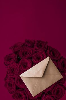 Holidays gift, floral present and happy relationship concept - Love letter and flowers delivery on Valentines Day, luxury bouquet of roses and card on maroon background for romantic holiday design