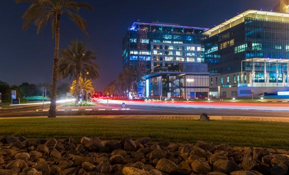 Dubai, UAE - 05.28.2021 Night street with light trails from the cars at Dubai International Financial center
