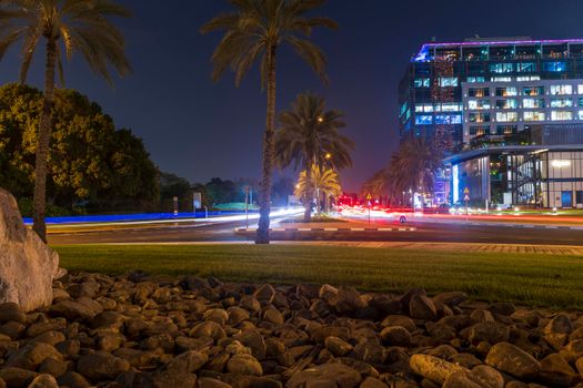 Dubai, UAE - 05.28.2021 Night street with light trails from the cars at Dubai International Financial center