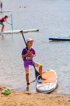 Children stand on the beach with surfboards. Paddleboarding. Russia Zelenograd 14 August 2021