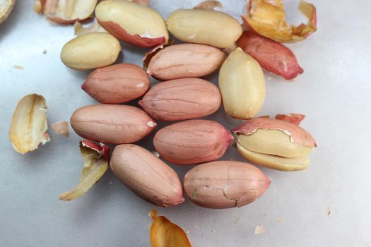Peeled peanut with shells. Food background of peanuts