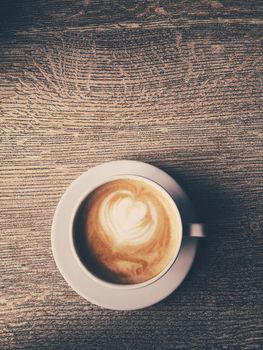 Morning drink, breakfast and rustic style concept - Cup of hot cappuccino in a cafeteria, coffee on a wooden table in cafe