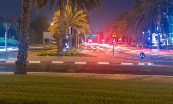 Dubai, UAE - 05.28.2021 Night street with light trails from the cars at Dubai International Financial center